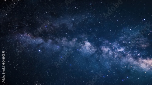 The image showcases a beautiful night sky dotted with stars and subtle nebula formations photo
