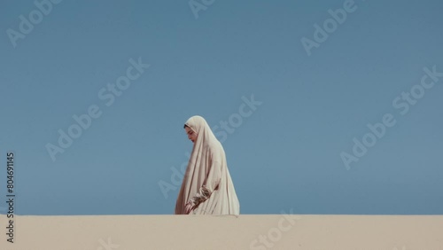Sand Dunes and a Woman wearing Hijab