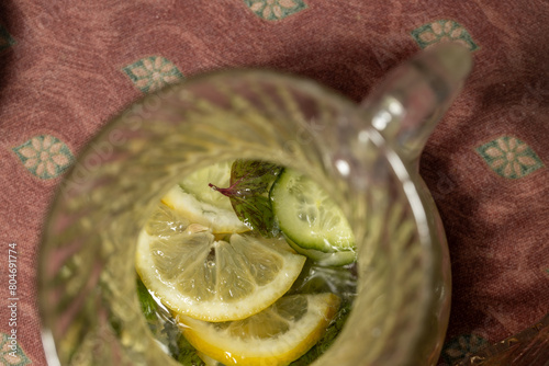 Lemonade with lemon slices and mint leaves in a jug - birdeye view photo
