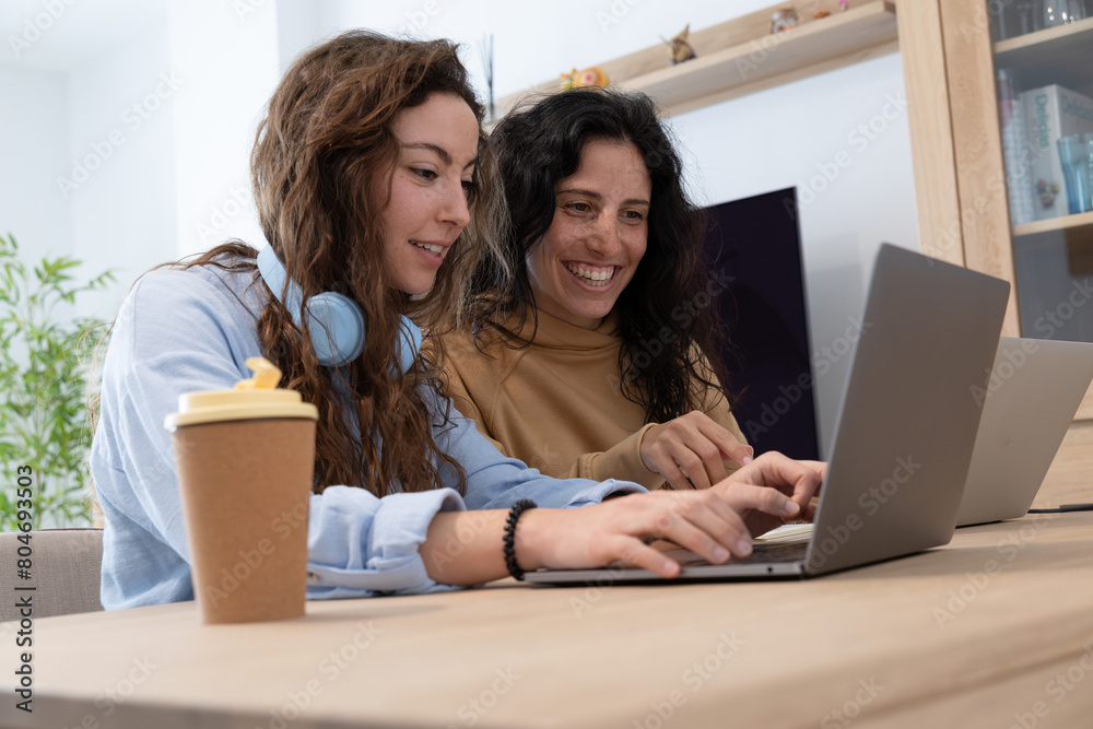 happy friends with their laptops working at home happy friends with their laptops working at home
