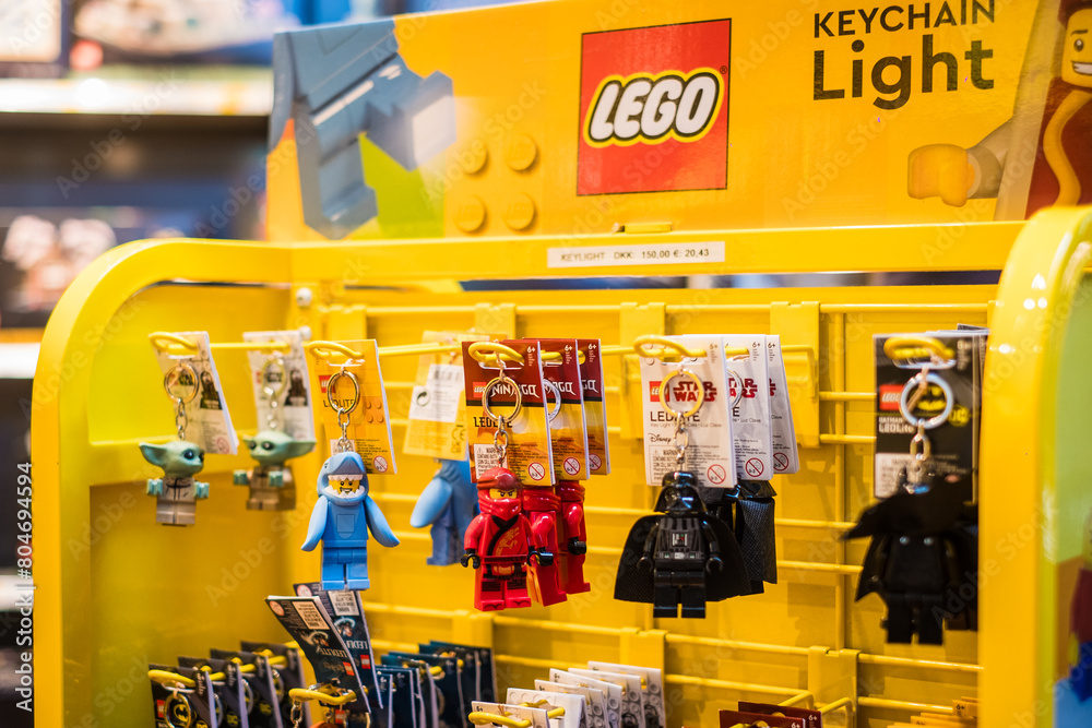 Obraz premium Copenhagen, Denmark - April 7, 2024: Lego keyrings Lego brand shop in Copenhagen Airport. Legos are interlocking plastic bricks.