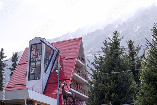 Hotel in the mountains on a spring day. Ala Archa national park, Kyrgyzstan, Central Asia. photo