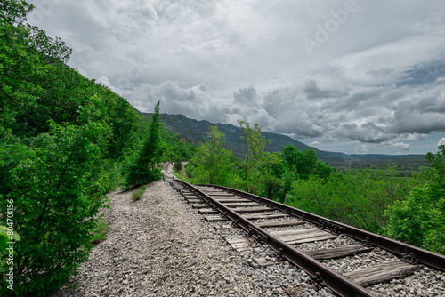 Pijana pruga or drunk railway in Istria, Croatia. A stretch of neglected railway track and bed, deformed rails, washed down by land slide or poor earth base photo