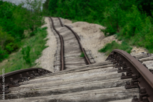 Pijana pruga or drunk railway in Istria, Croatia. A stretch of neglected railway track and bed, deformed rails, washed down by land slide or poor earth base photo