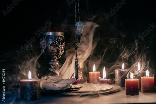 Fotografija Mysterious Occult Ceremony with Pendulum and Mystic Symbols.