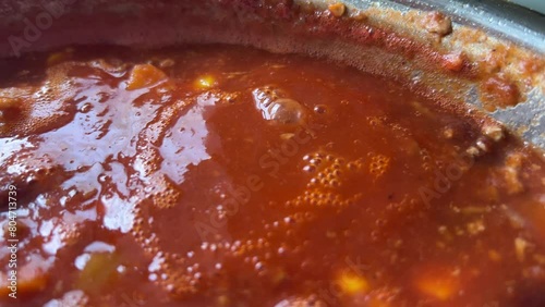 cooking delicious chili con carne in steel pot
