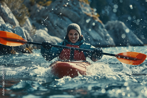 Whitewater kayaking, an extreme sport. A kayaker navigates through turbulent mountain rapids © elinorka