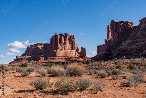 Low angle view of Courthouse Towers on a Spring day with blue skies in Arches National Park 