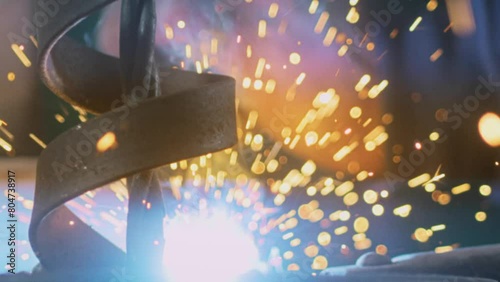 Person welding with a welding-torch and creating sparks photo