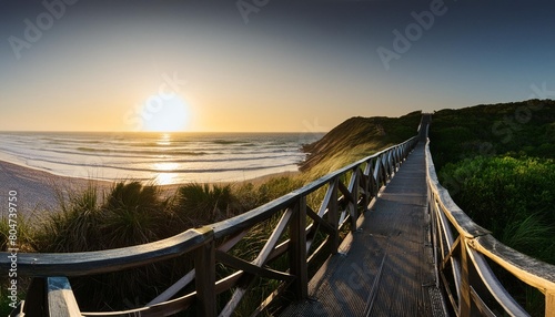 panorama view of footbridge to beach at sunrise