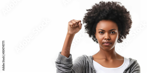 Empowered young woman confidently raising her fist in solidarity, white background.