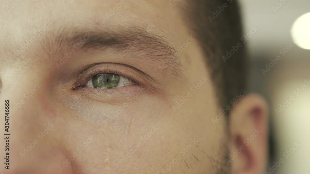 Sad man crying with tears in eye. Teardrop on face. Drama, depression concept