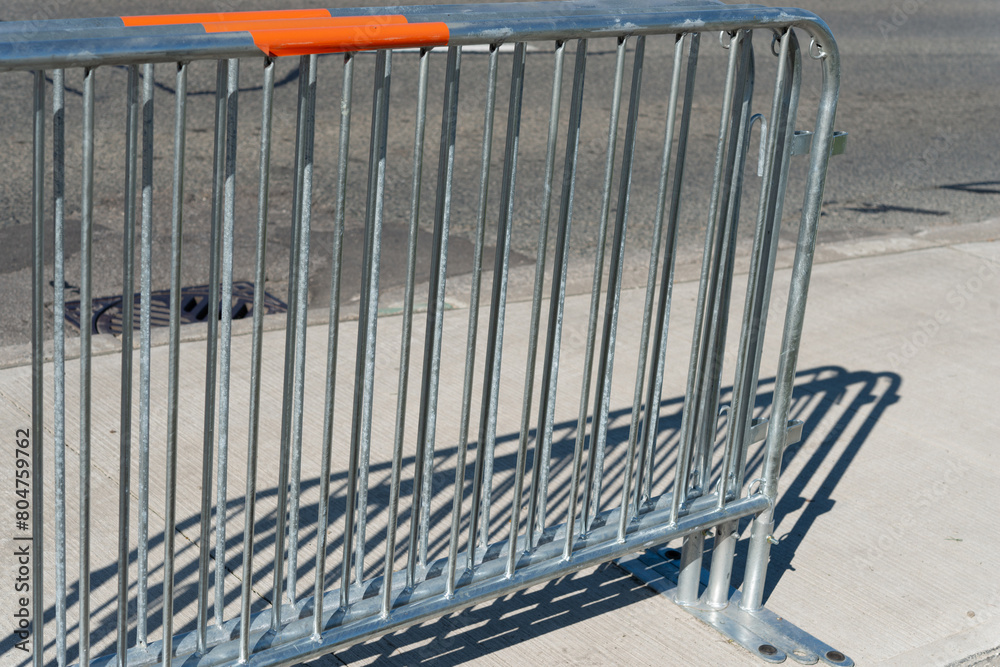 detail of several barrier fences on a sidewalk outside in spring detail of several barrier fences on a sidewalk outside in spring