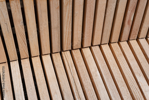 close-up of wooden structure composed of various lengths of hardwood slats