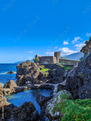 Sao Joao Baptista Fort of Porto Moniz. Volcanic rocks, coast, natural pool and the Atlantic Ocean landscape. Madeira, Portugal photo