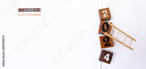 Junio 2024. Espacio para copiar contenido, objetivos y metas o resultados del mes. Cubos, bloques y escalera de madera. Fondo blanco.  photo
