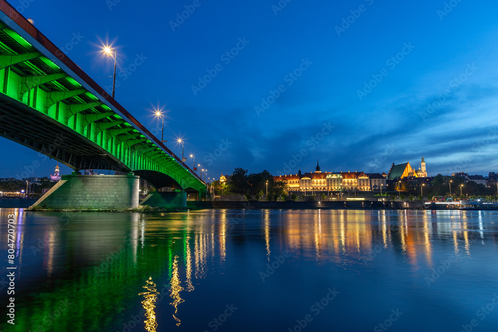 evening view of the Warsaw embankment in Poland and the royal palace