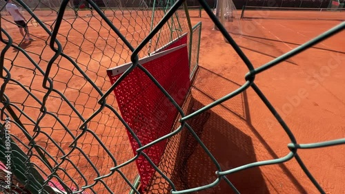 tennis court dragnet hanging on fence