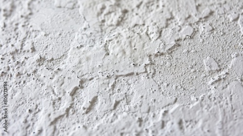 Close-up of a white rough plaster wall texture.