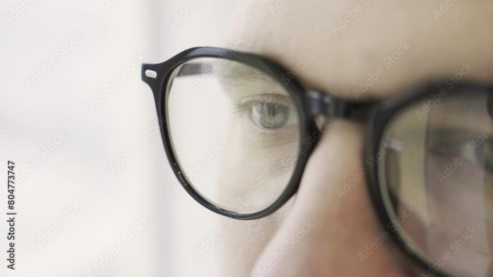 Man eyes in eyeglasses looking intently forward, isolated on white, Close up Man eyes in eyeglasses looking intently forward, isolated on white, Close up