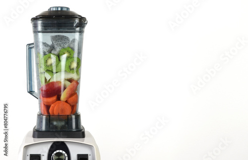 Mix various fruits and vegetables in a blender to make healthy smoothies. On a white background with copy space and clipping path.