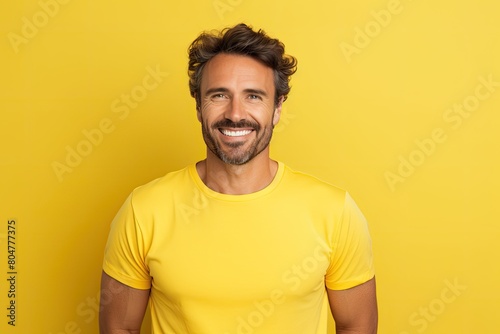 smiling man in yellow shirt