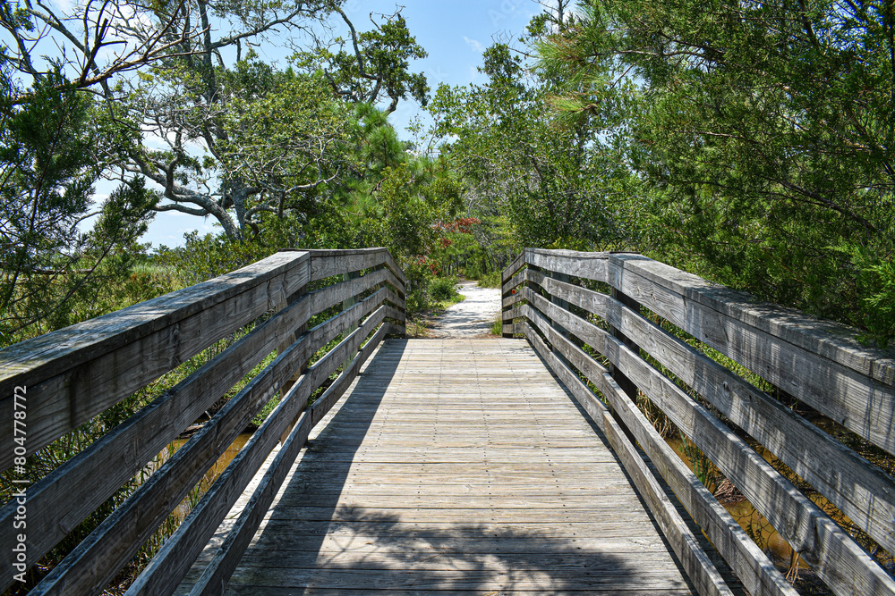 wooden bridge to a sandy path at the beach wooden bridge to a sandy path at the beach