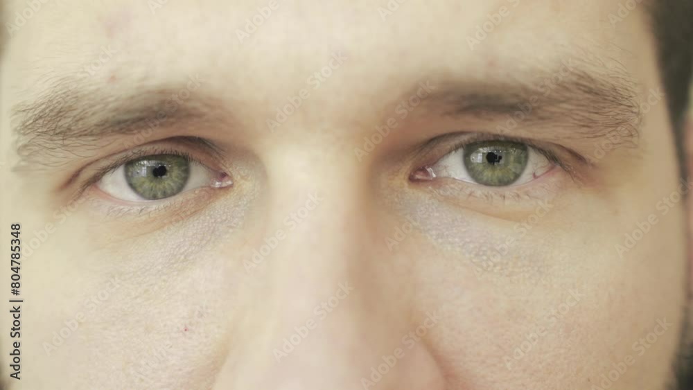 Close up of young man thinking about something, looking at camera. Slow motion Close up of young man thinking about something, looking at camera. Slow motion