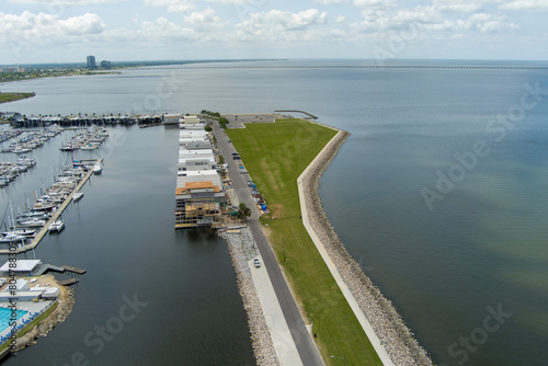 Wallpaper Mural aerial shot of a gorgeous spring landscape at Breakwater Park with ocean water, lush green trees and grass, rocks, blue sky and clouds in New Orleans Louisiana USA Torontodigital.ca