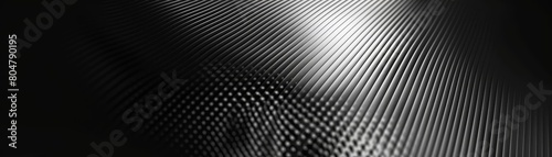 Generate a seamless carbon fiber texture with a subtle lighting effect. The image should be dark and moody, with the carbon fiber weave barely visible in the shadows. photo