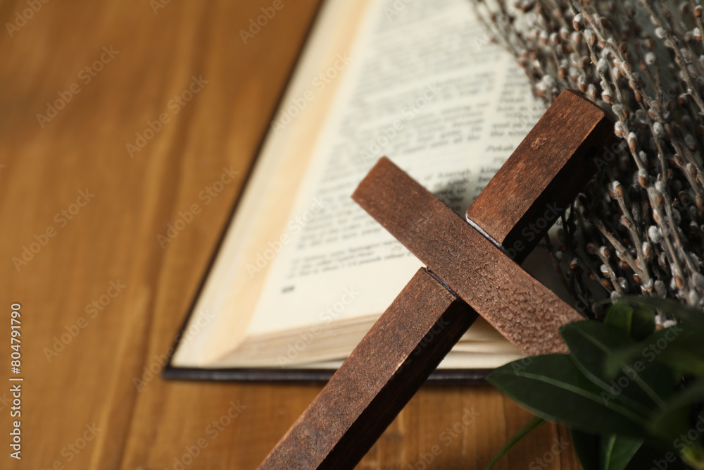 Obraz premium Cross, Bible and willow branches on table, closeup. Space for text