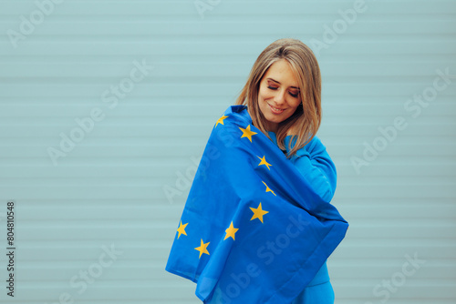 Girl Holding a EU Flag Celebrating the European Union. European citizen celebrating Europe Day feeling carefree and cheerfu
