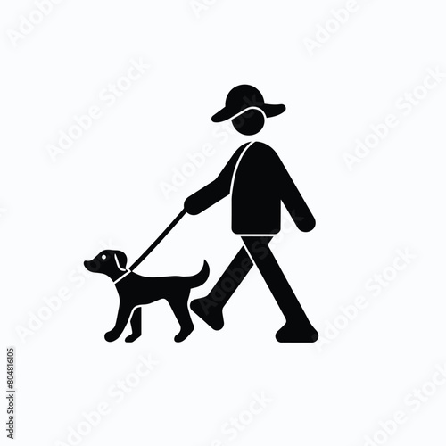 Silhouette of a person walking a dog on a leash.