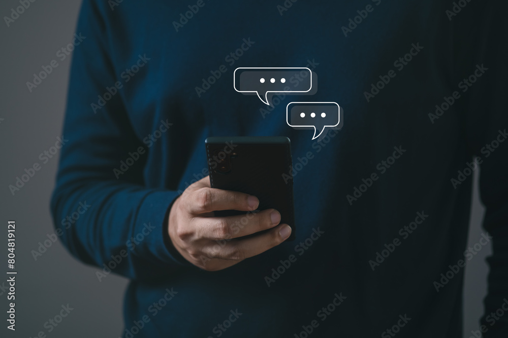 Man using smartphone typing Live chat chatting and social network concepts, chatting conversation working on mobile phone in chat box icons pop up. Social media marketing technology concept. Man using smartphone typing Live chat chatting and social network concepts, chatting conversation working on mobile phone in chat box icons pop up. Social media marketing technology concept.