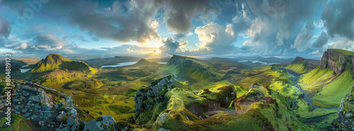 Scenic view of beautiful landscape the Quiraing, Isle of Skye, Scotland from above with view into the valley and hills in the background and dramatic clouds in the sky