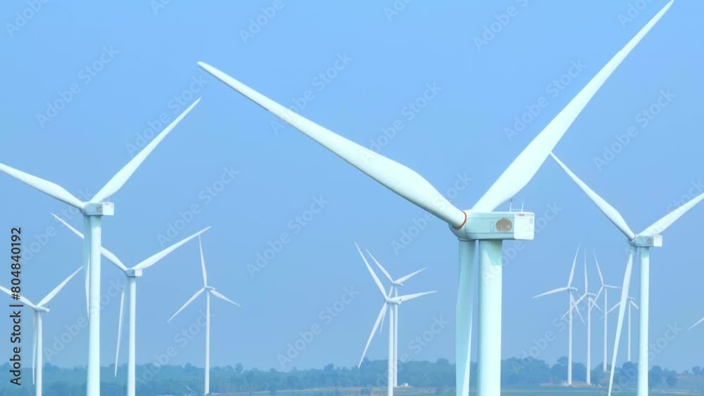 A sprawling forest of sleek white wind turbines stands tall, harnessing the power of the wind to fuel clean energy. Aerial view drones capture their towering presence against the horizon.
A sprawling forest of sleek white wind turbines stands tall, harnessing the power of the wind to fuel clean energy. Aerial view drones capture their towering presence against the horizon.