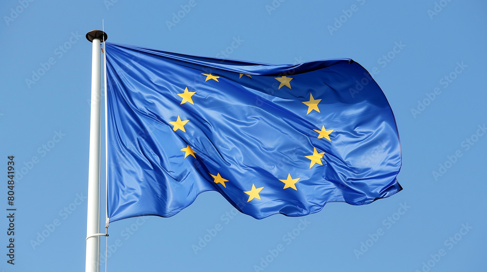 An illustration of the European flag, featuring a single plain blue color with twelve gold stars arranged in a circle on a plain background resembling a blue sky. The flag's design is minimalist An illustration of the European flag, featuring a single plain blue color with twelve gold stars arranged in a circle on a plain background resembling a blue sky. The flag's design is minimalist