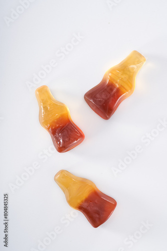 Creative atmosphere of sweet soft soda gummies on white background