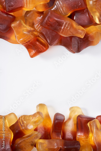 Creative atmosphere of sweet soft soda gummies on white background