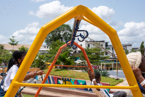 Kids having fun on a swing at a playgrown during a pop-up event in Lagos, Nigeria on April 13, 2024.