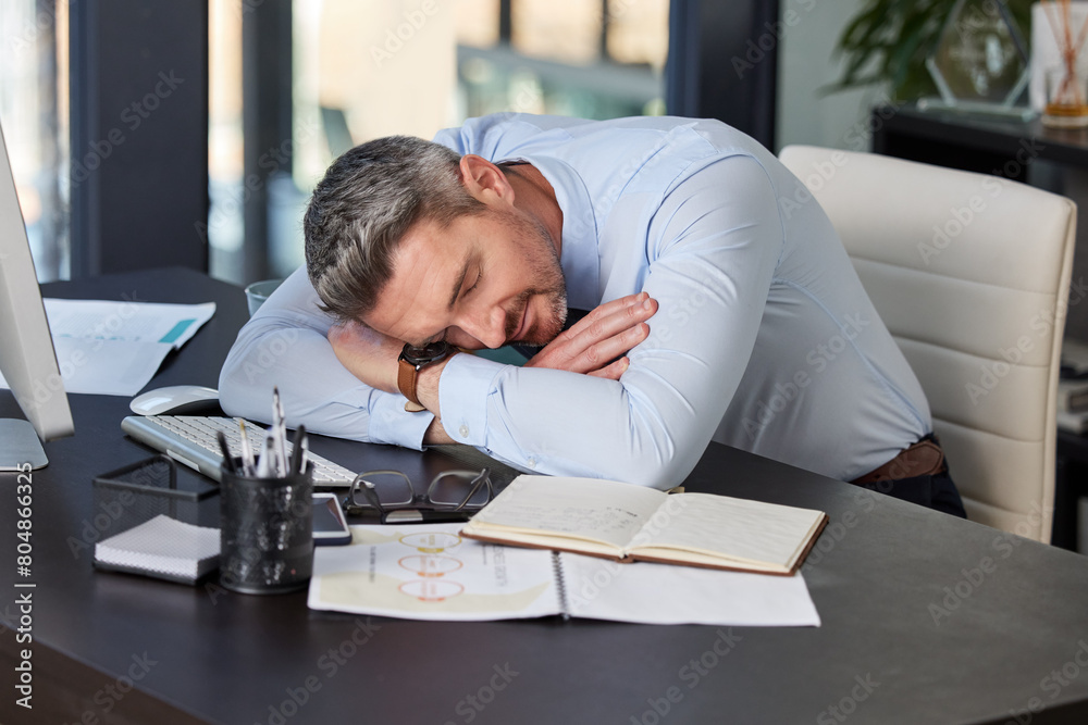 Tired, business man and sleeping at desk in office with resting, nap or burnout from working on report. Exhausted, professional and male employee for fatigue, deadline stress or snooze in workplace Tired, business man and sleeping at desk in office with resting, nap or burnout from working on report. Exhausted, professional and male employee for fatigue, deadline stress or snooze in workplace