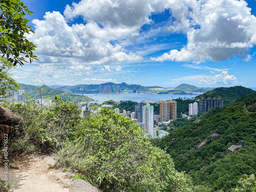 Urban Oasis: Skyline Meets Lush Greenery Under Cloudy Skies, Hong Kong