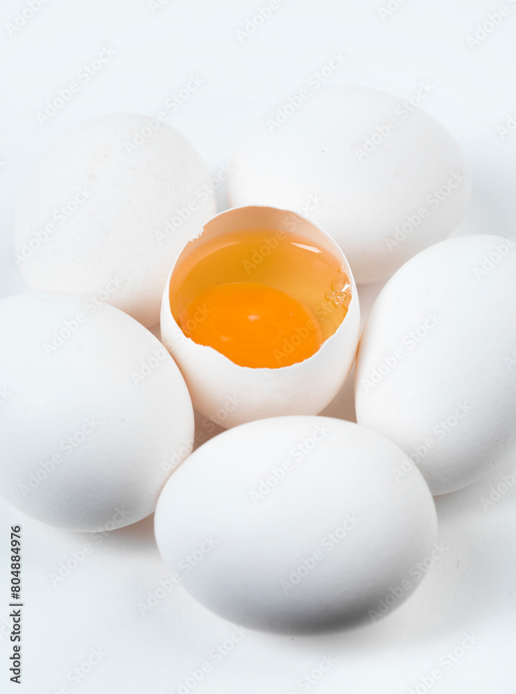white chicken eggs on a white background, free range orange yolk white chicken eggs on a white background, free range orange yolk