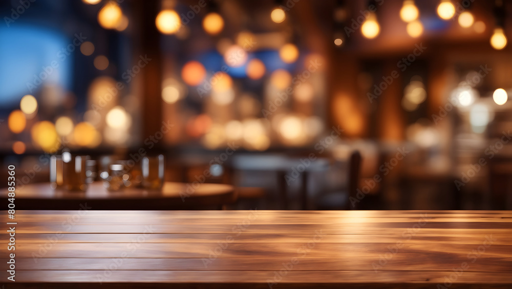Image of empty wooden table in front of abstract blurred restaurant lights background