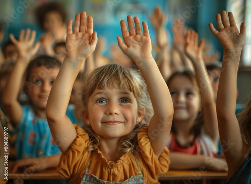 Happy children raising their hands in class, symbolizing the importance and inspiration that learning brings to them, under natural lighting and sharp focus. © Duka Mer