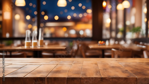 Image of empty wooden table in front of abstract blurred restaurant background