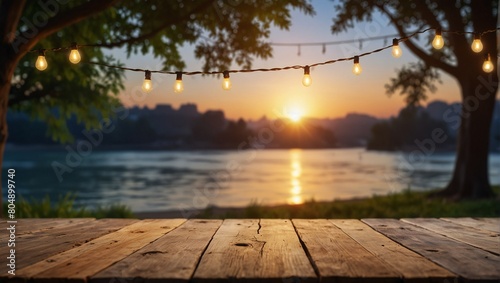 Empty Wood table top with decorative outdoor string lights hanging on tree in the garden   Daylight saving time end  real estate concept and blurred landscape of river beach Blue sky with sunset
