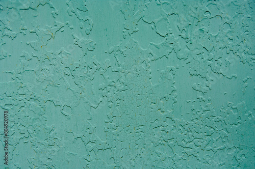Old paint on metal. Peeling paint on a metal fence. Painted over old paint.