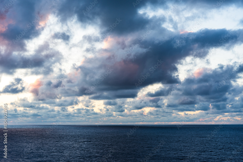 Dramatic sunset sky over the calm ocean. 