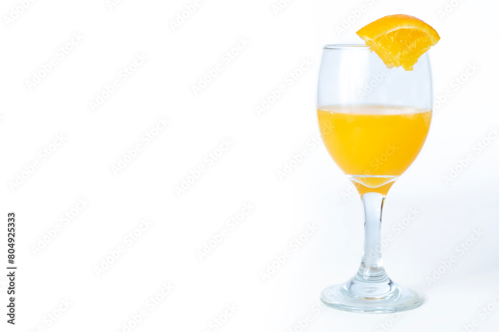 Fresh orange juice in a glass on a white background